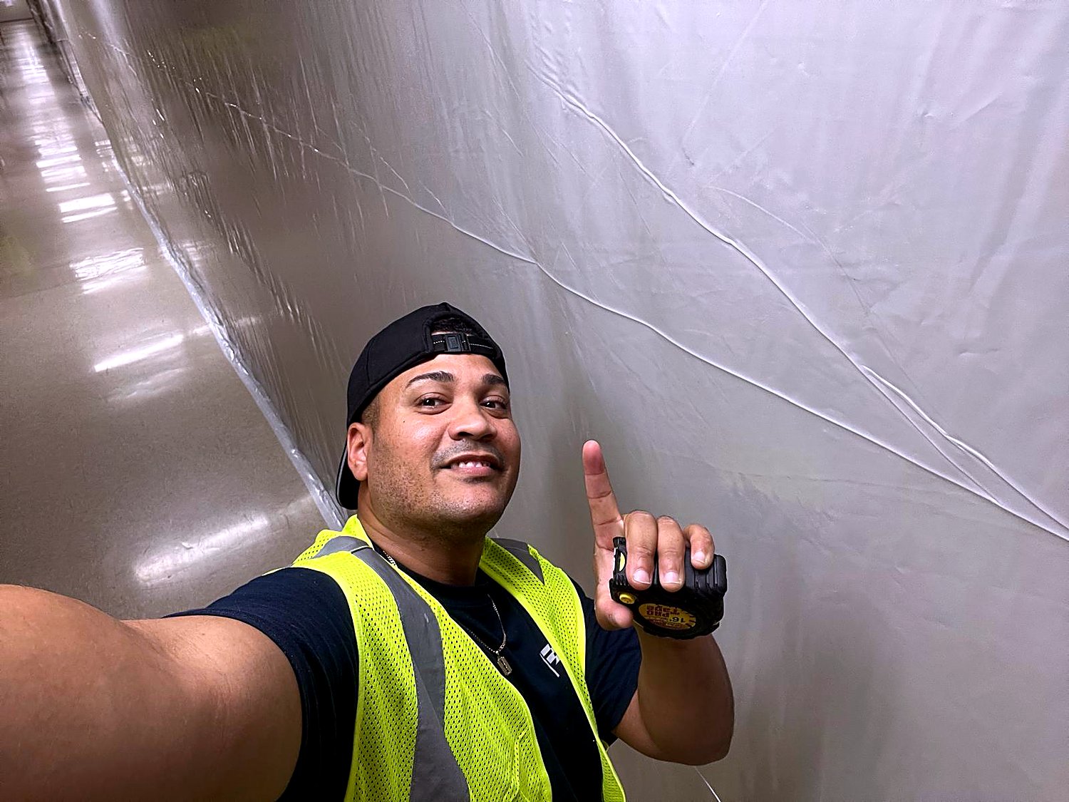 En obra, midiendo con equipo de seguridad